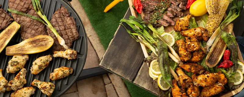 foods on a grill next to grilled foods on a table