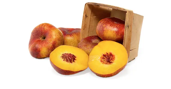 Yellow donut nectarines in a crate