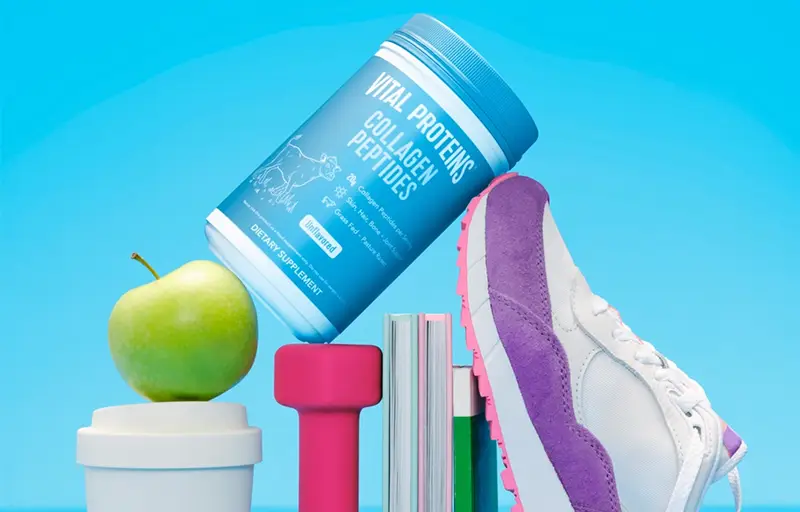 Vital Proteins Collagen Peptides balanced on top of workout gear.